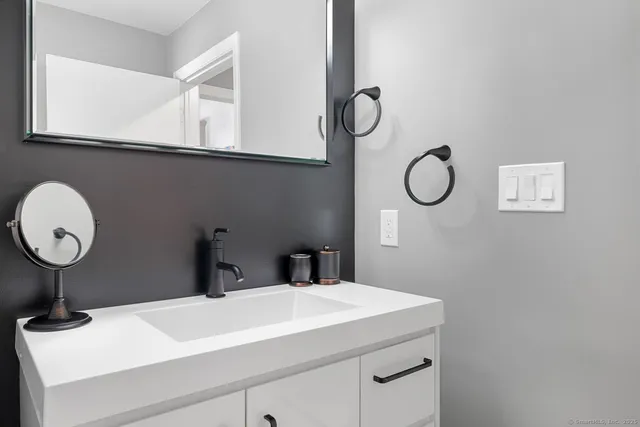 a bathroom with a sink and a mirror