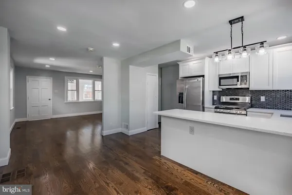 a view of kitchen with sink microwave and refrigerator