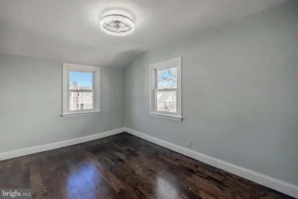 a view of a room with wooden floor and window
