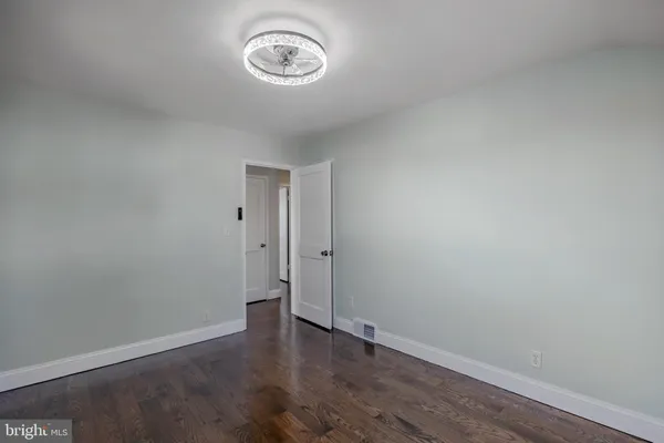 a view of a room with wooden floor and a window