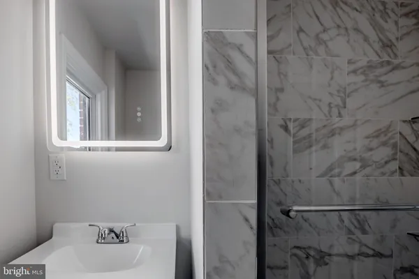 a bathroom with a sink and mirror