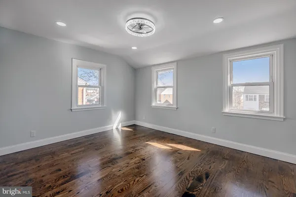 a view of a room with wooden floor and window
