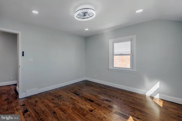a view of a room with wooden floor and window