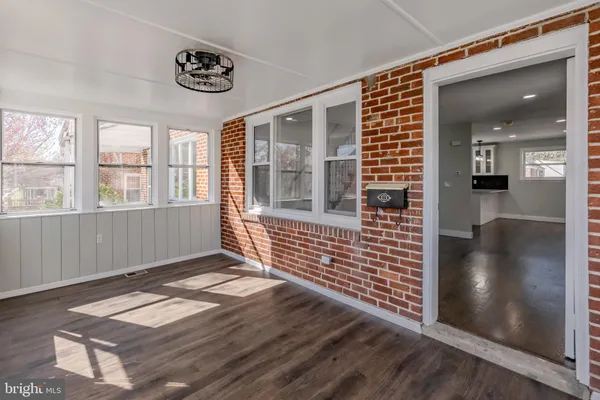 a view of wooden floor and a window in a room