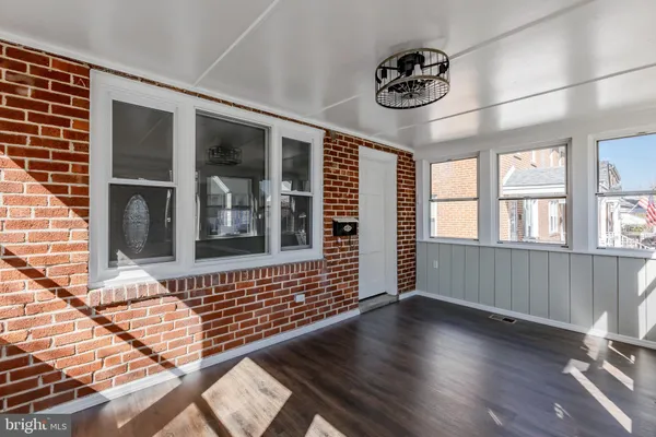 a view of a livingroom with wooden floor and stairs