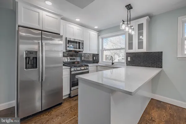 a kitchen with stainless steel appliances a refrigerator sink and microwave