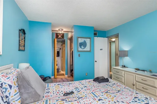 a bedroom with a bed and a dresser