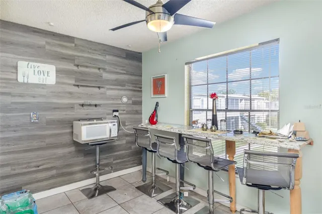 a kitchen with a dining table chairs and white appliances