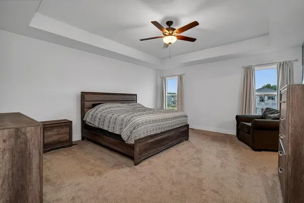 a bedroom with a bed and a chandelier