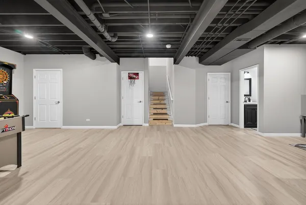 a view of an empty room with wooden floor
