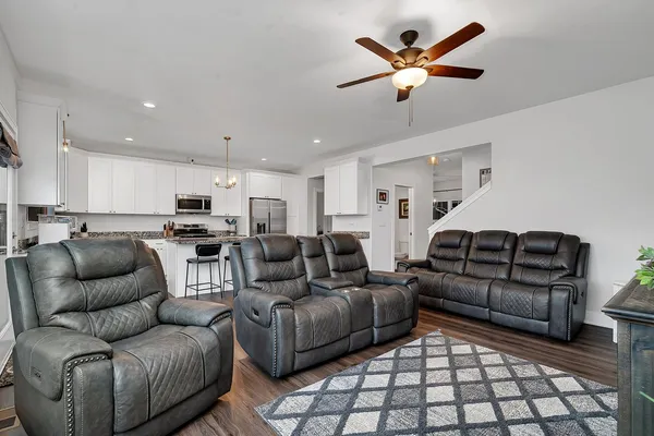 a living room with furniture and kitchen view