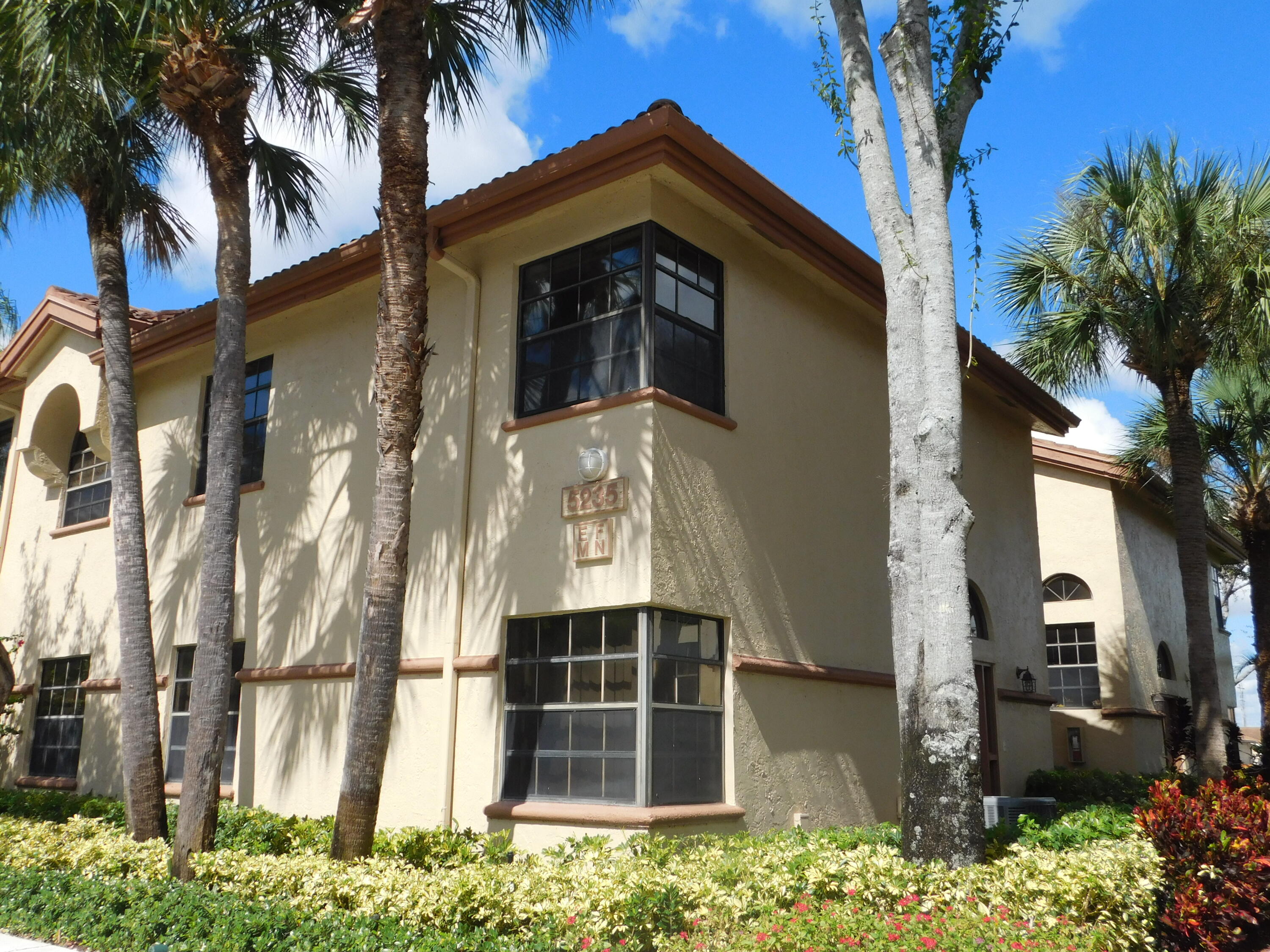 5235 Europa Drive, Unit E Boynton Beach, FL 33437 - Photo 1 of 57 a view of a house with a yard