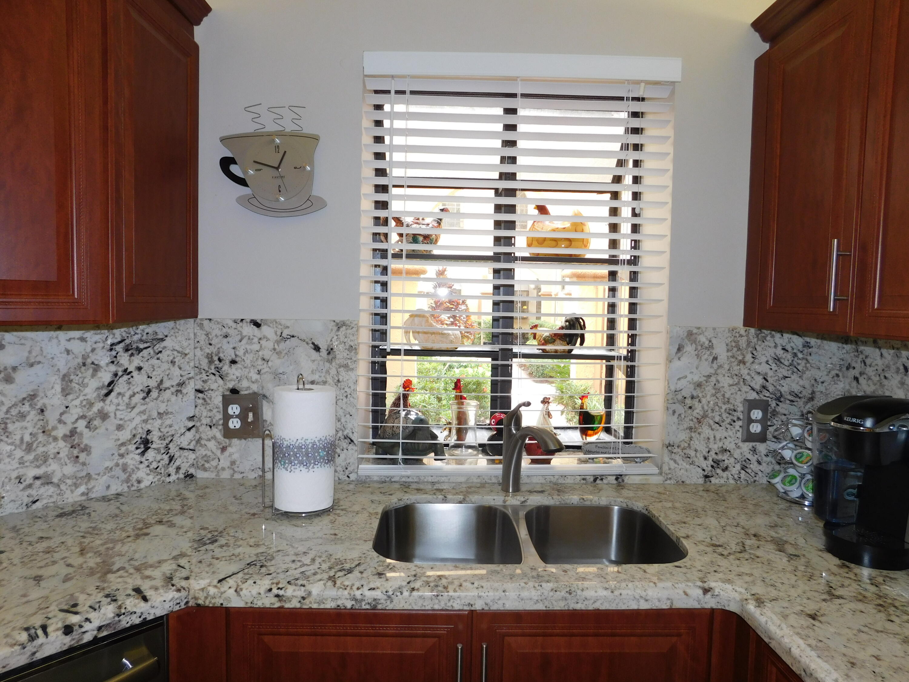 5235 Europa Drive, Unit E Boynton Beach, FL 33437 - Photo 12 of 57 a kitchen with granite countertop a sink and a window