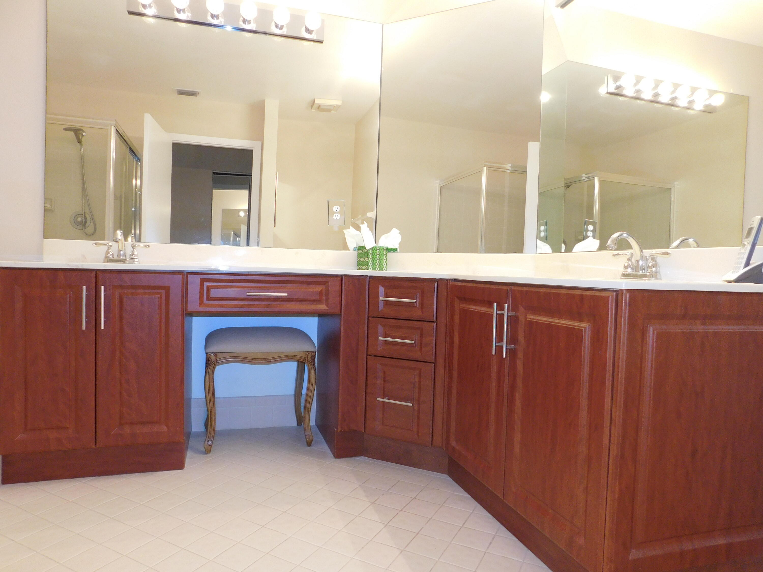 5235 Europa Drive, Unit E Boynton Beach, FL 33437 - Photo 17 of 57 a bathroom with a sink and a large mirror