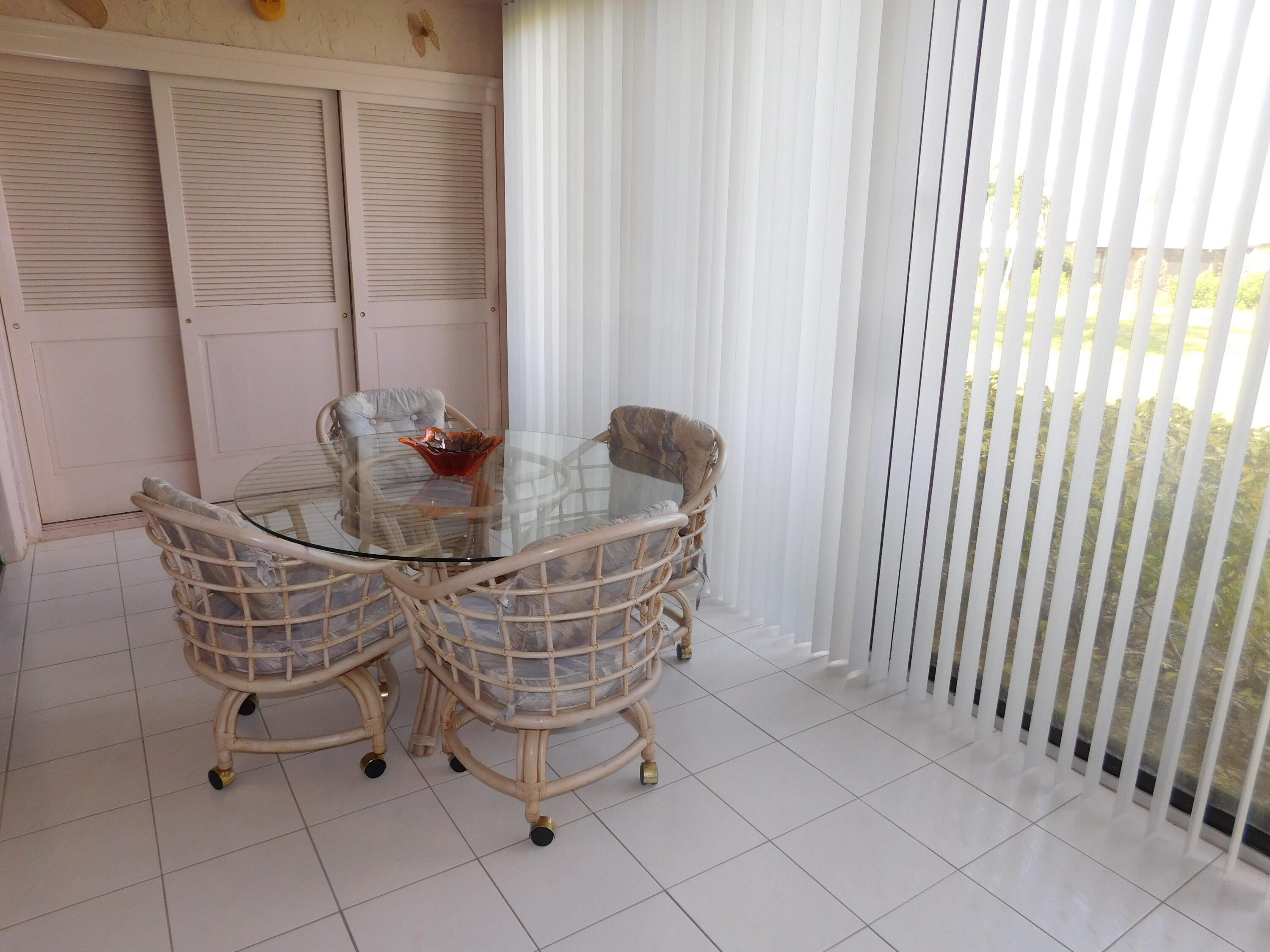 5235 Europa Drive, Unit E Boynton Beach, FL 33437 - Photo 20 of 57 a dining room with furniture and window