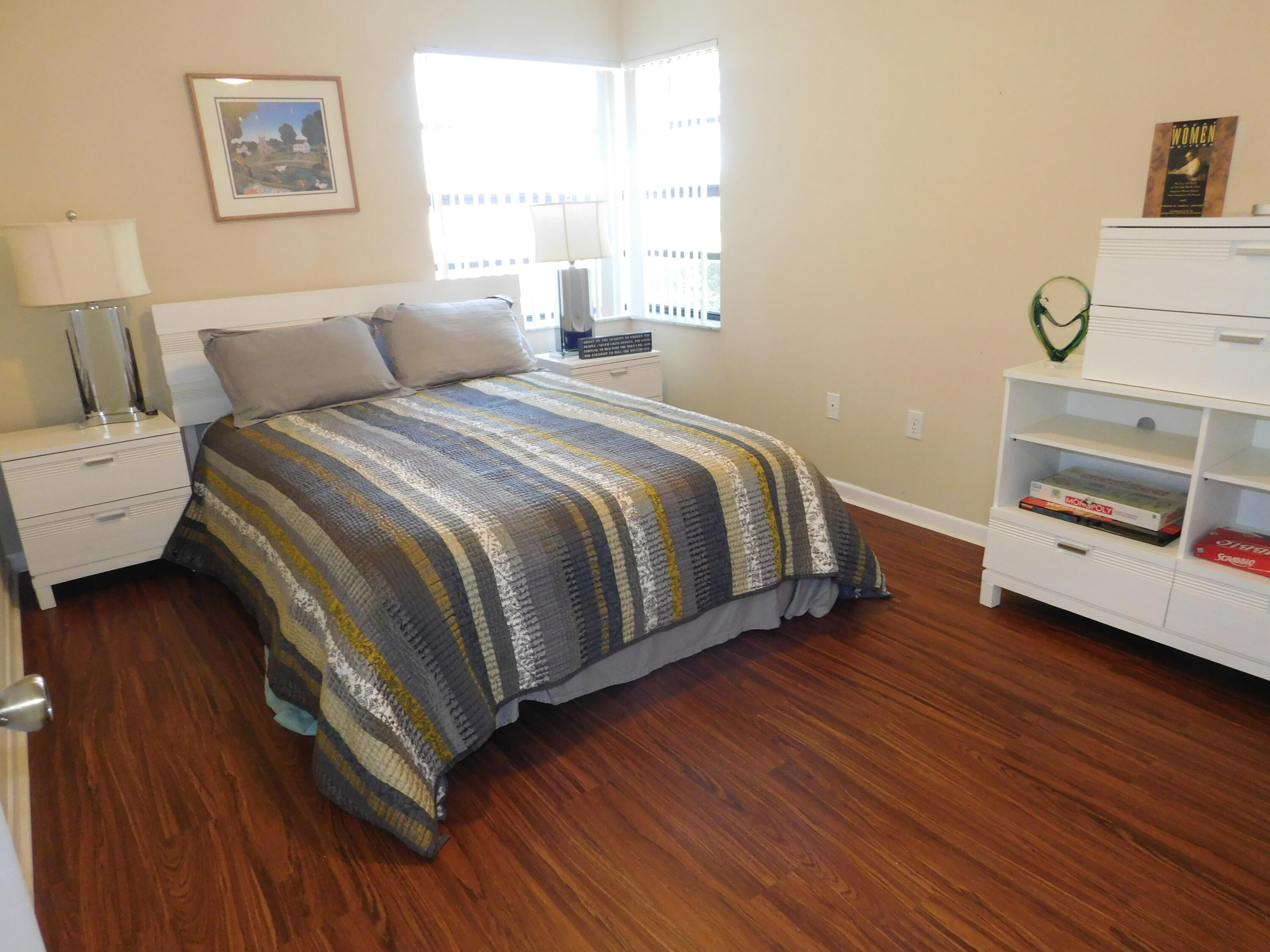 5235 Europa Drive, Unit E Boynton Beach, FL 33437 - Photo 24 of 57 a bedroom with a bed and a window