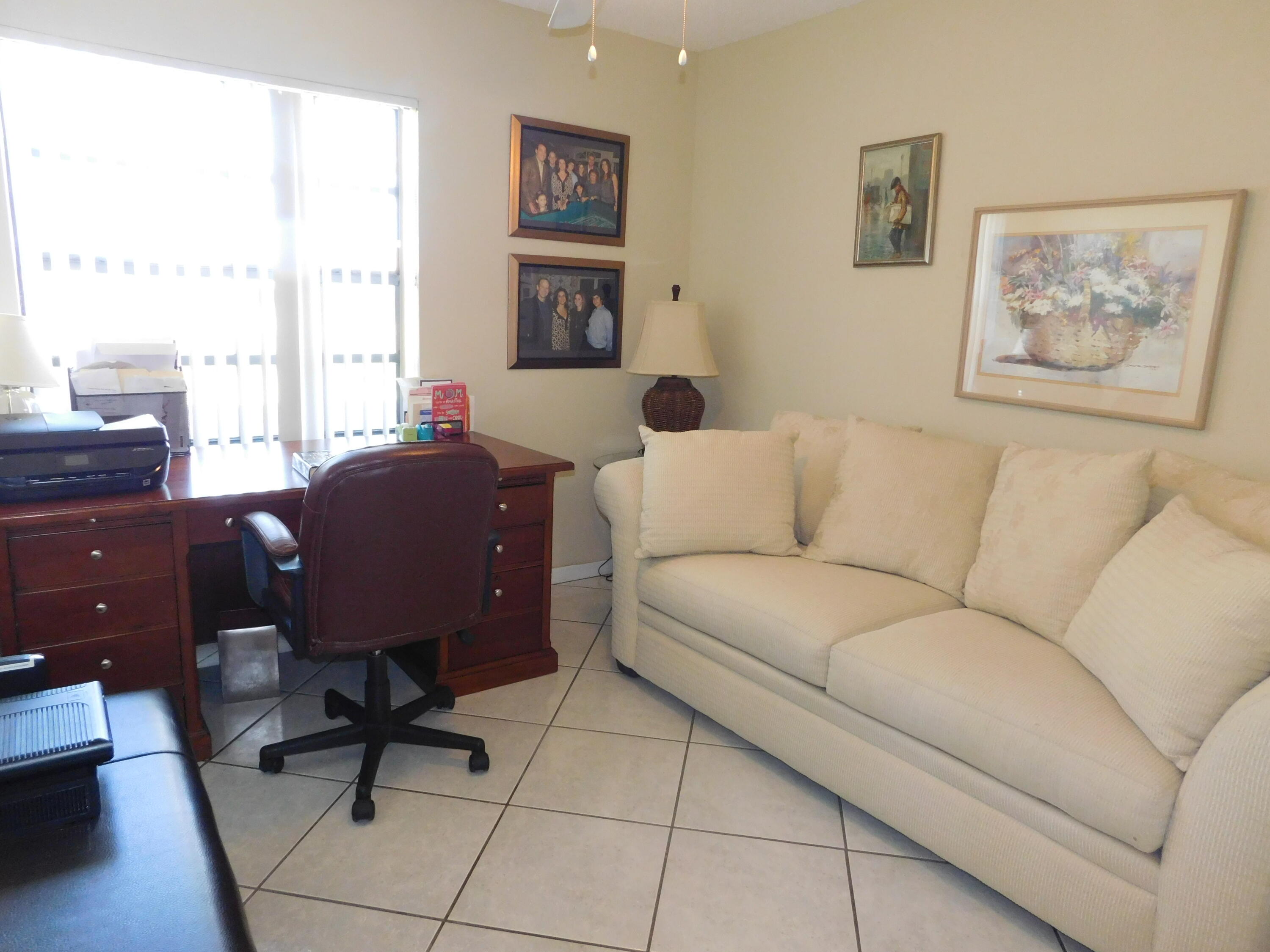 5235 Europa Drive, Unit E Boynton Beach, FL 33437 - Photo 27 of 57 a living room with furniture and a window