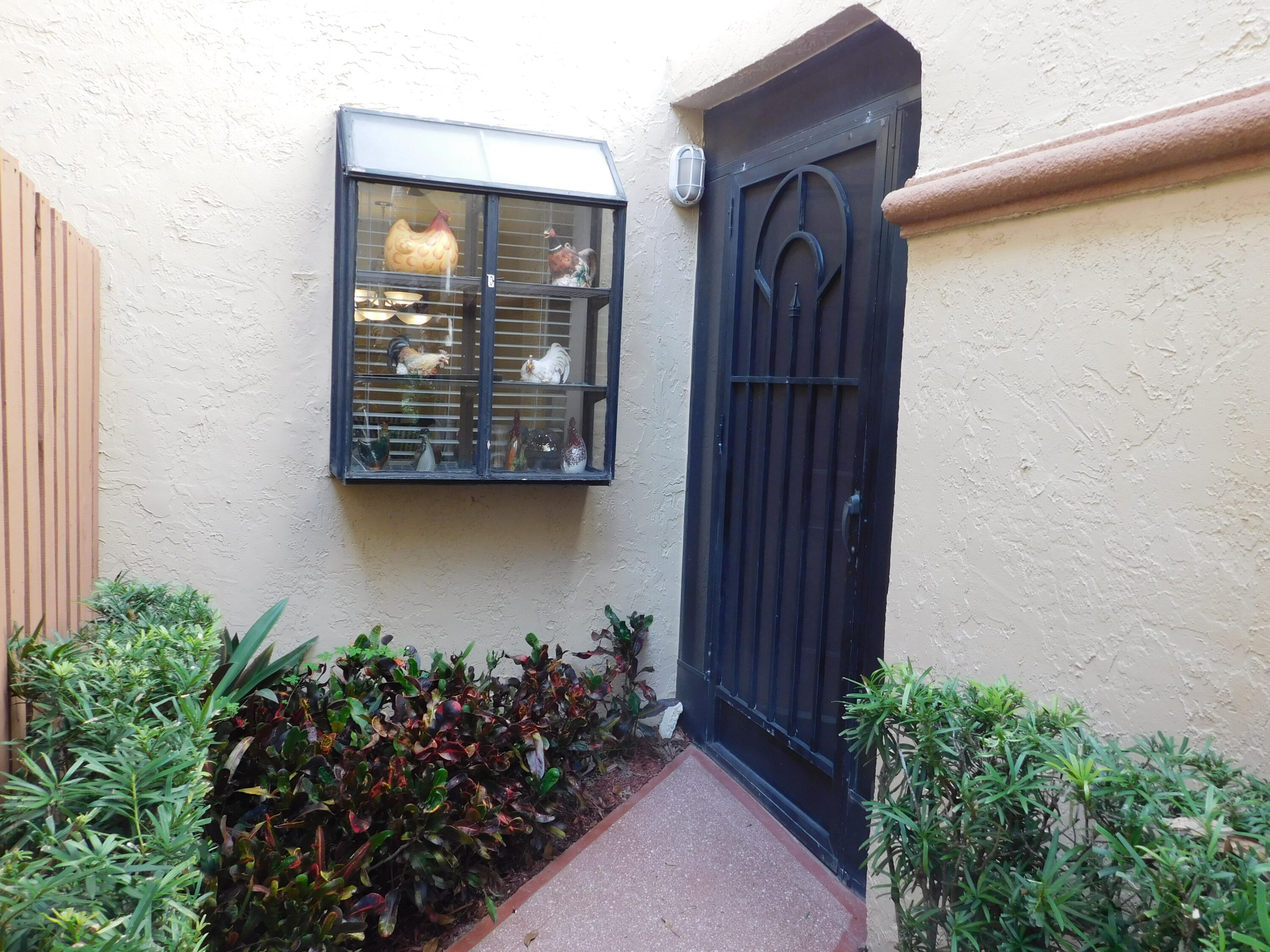 5235 Europa Drive, Unit E Boynton Beach, FL 33437 - Photo 3 of 57 a view of a entryway door of the house