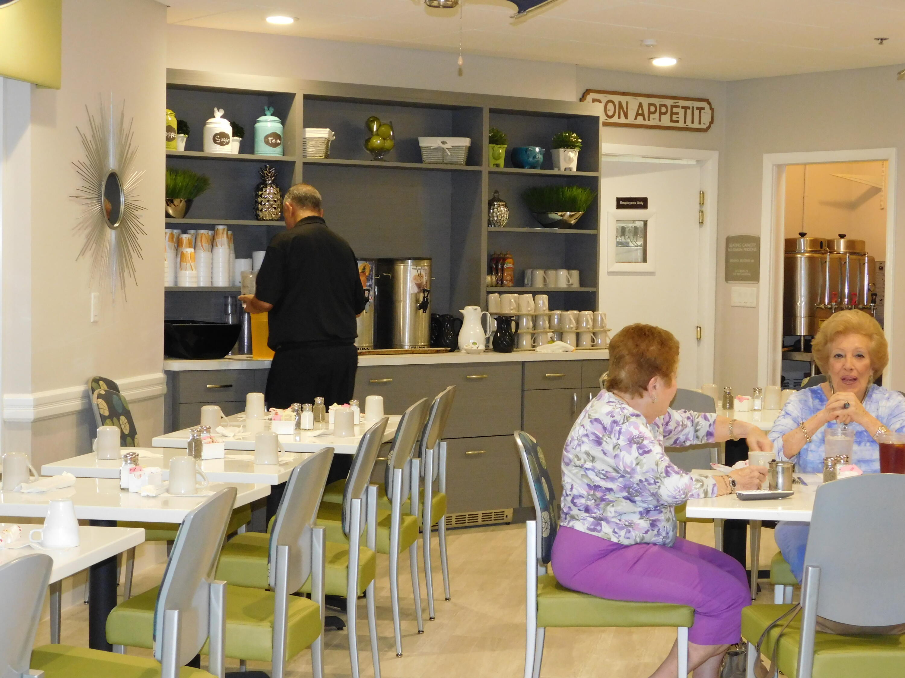 5235 Europa Drive, Unit E Boynton Beach, FL 33437 - Photo 38 of 57 a dining room with furniture and wooden floor
