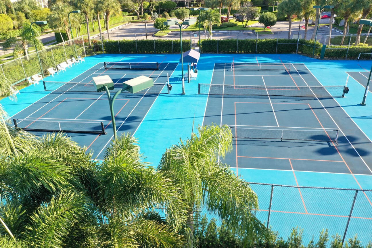 5235 Europa Drive, Unit E Boynton Beach, FL 33437 - Photo 44 of 57 a view of a chairs and table on the patio