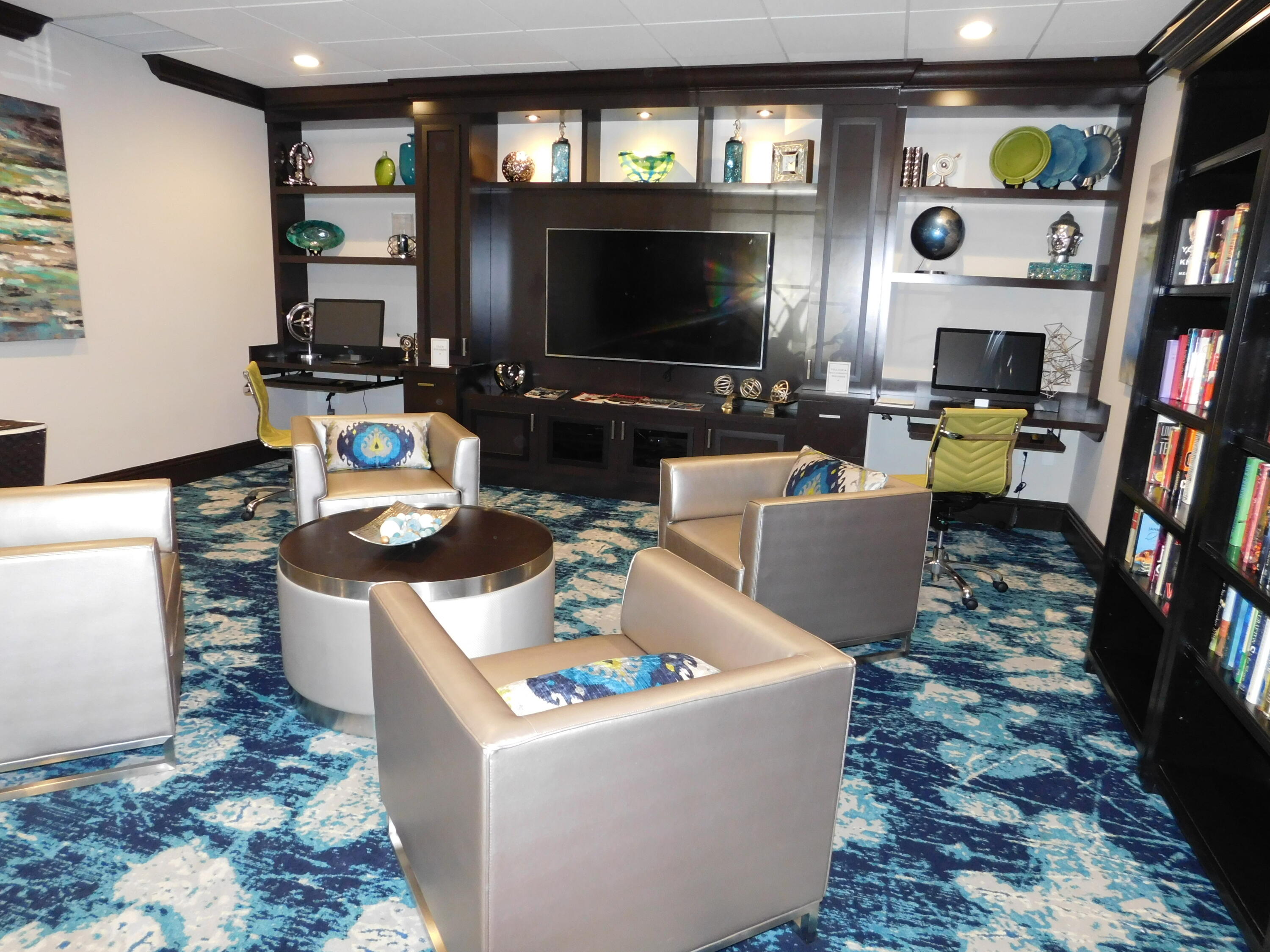 5235 Europa Drive, Unit E Boynton Beach, FL 33437 - Photo 53 of 57 a living room with furniture and a flat screen tv