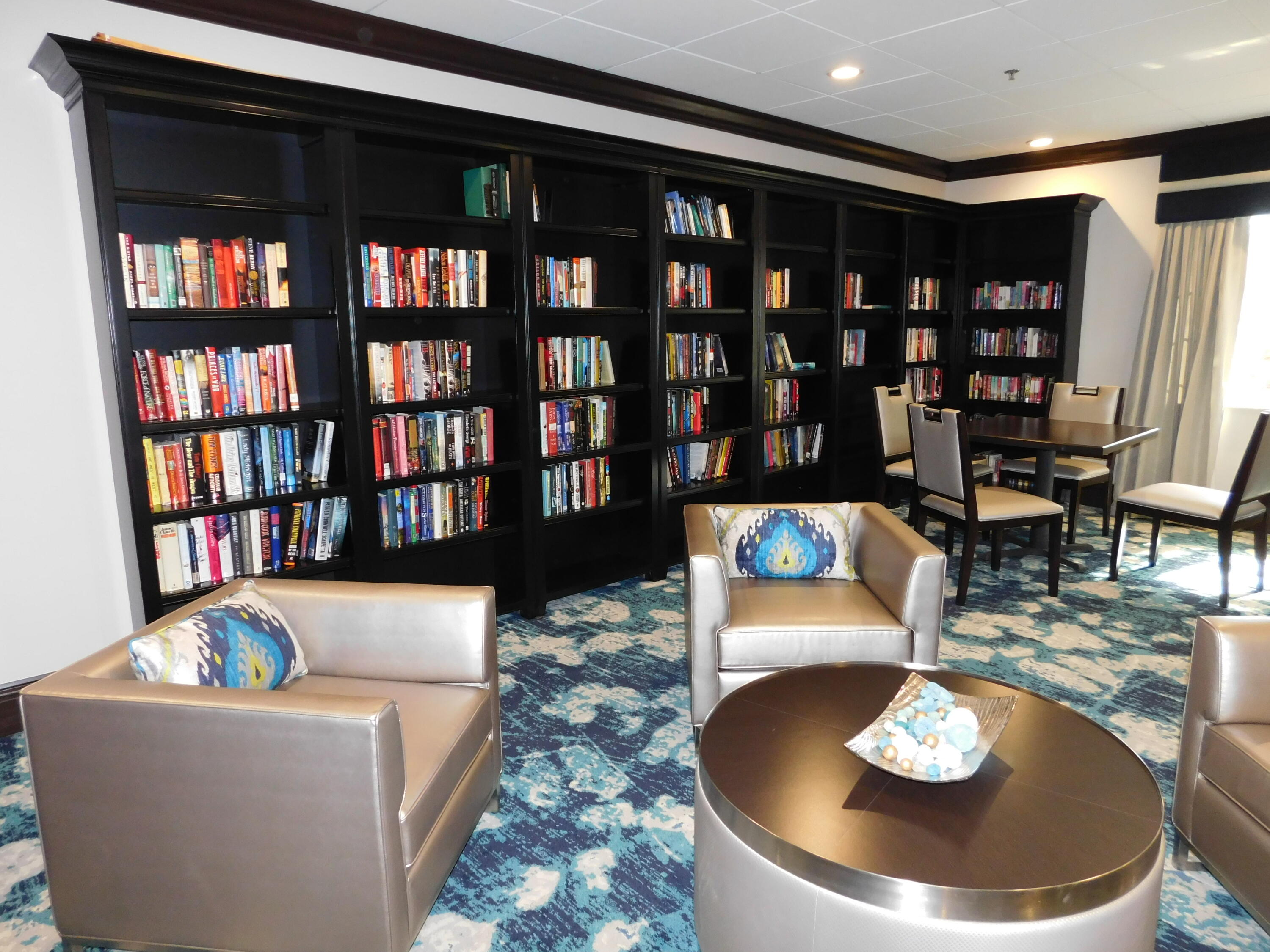 5235 Europa Drive, Unit E Boynton Beach, FL 33437 - Photo 54 of 57 a living room with furniture and a table