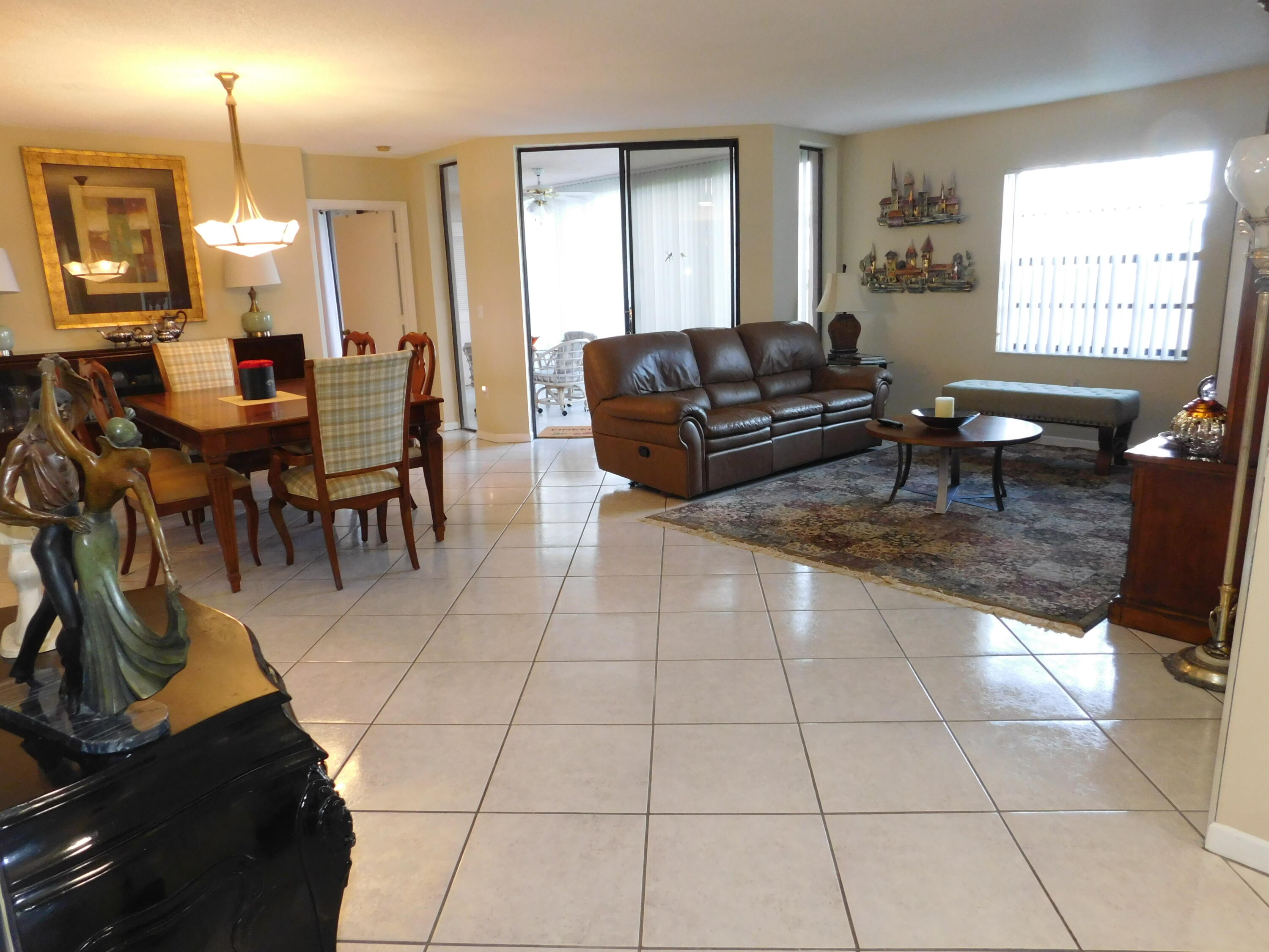 5235 Europa Drive, Unit E Boynton Beach, FL 33437 - Photo 6 of 57 a living room with furniture a window and a dining table