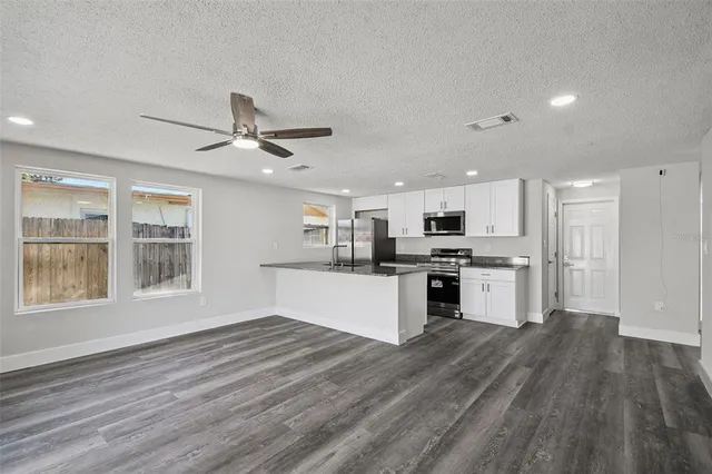 a kitchen with stainless steel appliances granite countertop a stove and a refrigerator