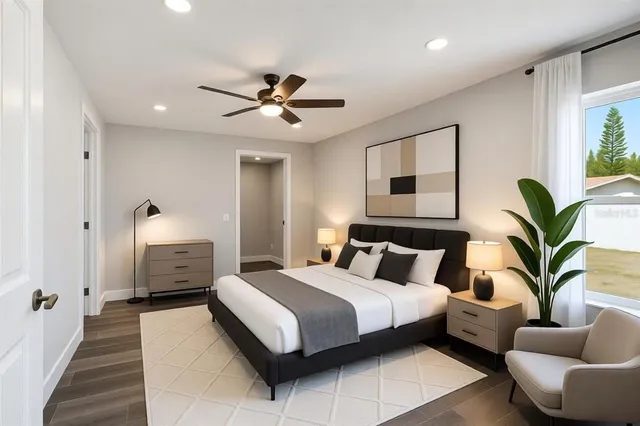 an empty room with wooden floor ceiling fan and windows