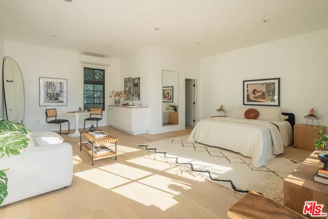 a bed room with a bed and a large window