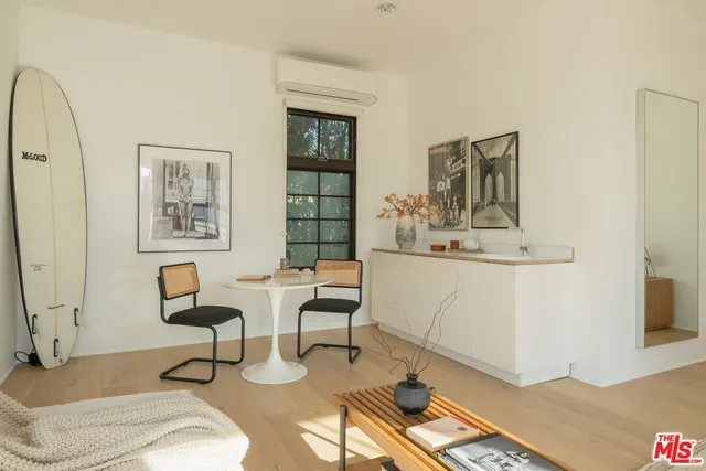 a bathroom with a window sink and tub