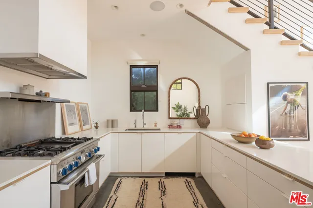 a kitchen with a sink stove and cabinets