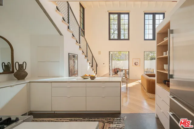 a dining room with furniture entryway and wooden floor
