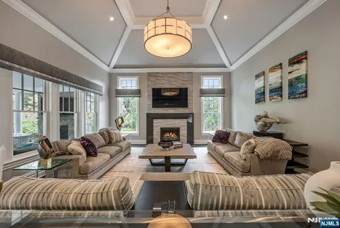 a living room with furniture a fireplace and a large window