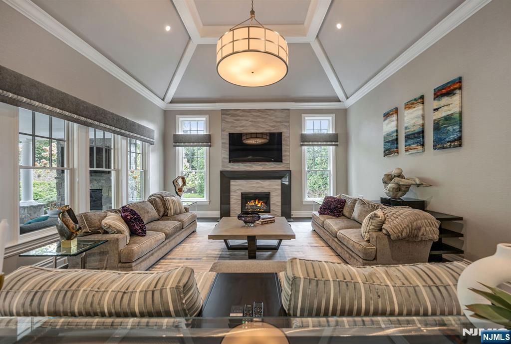 236 East Saddle River Road Saddle River, NJ 07458 - Photo 12 of 50 a living room with furniture a fireplace and a large window