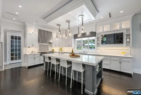 a kitchen with lots of counter top space and refrigerator