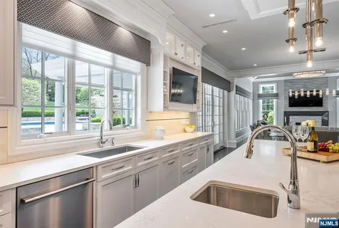 a kitchen that has a sink and a stove in it