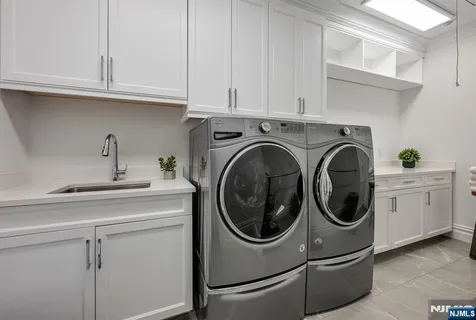 a utility room with sink dryer and washer