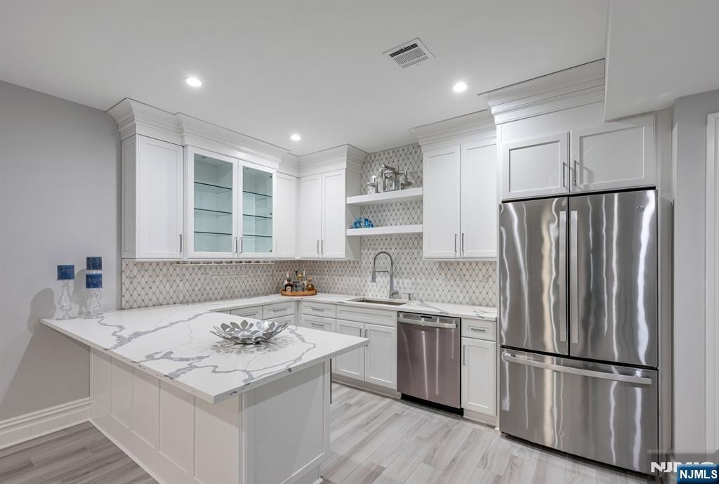 236 East Saddle River Road Saddle River, NJ 07458 - Photo 44 of 50 a kitchen that has a sink a refrigerator a window and white cabinets