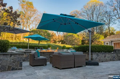 a view of patio with chairs and umbrellas