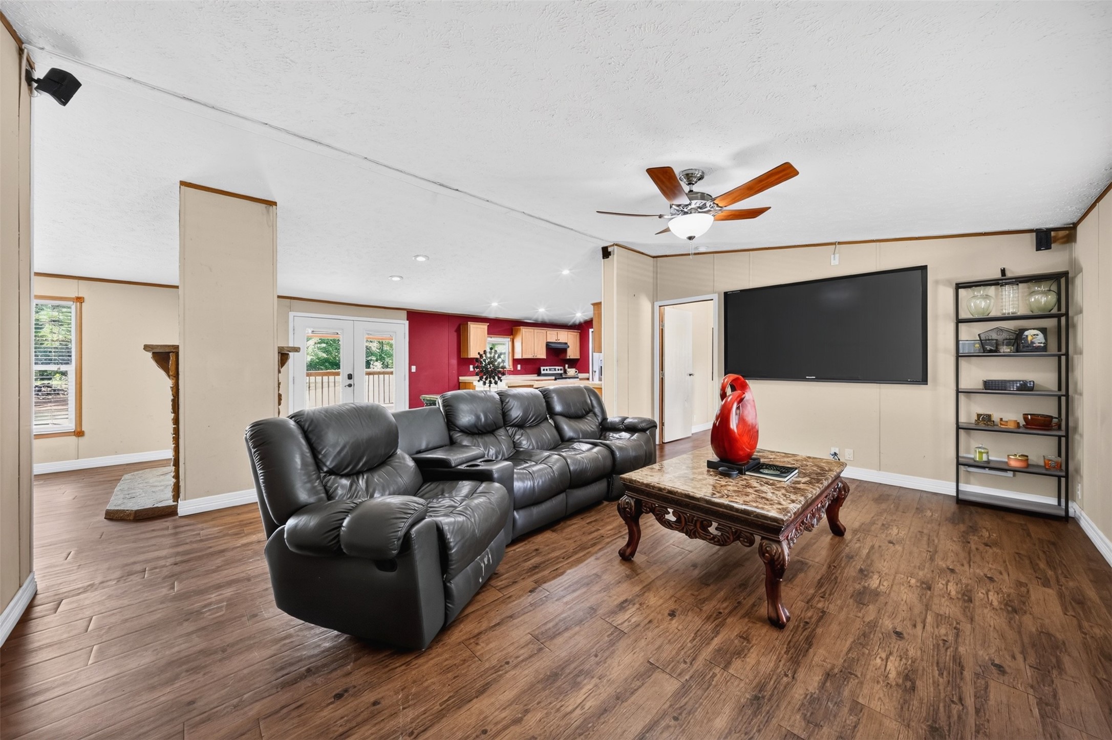 2581 Mann Road Conroe, TX 77303 - Photo 14 of 32 Bright living space with wood-look flooring, ceiling fan, and natural light.