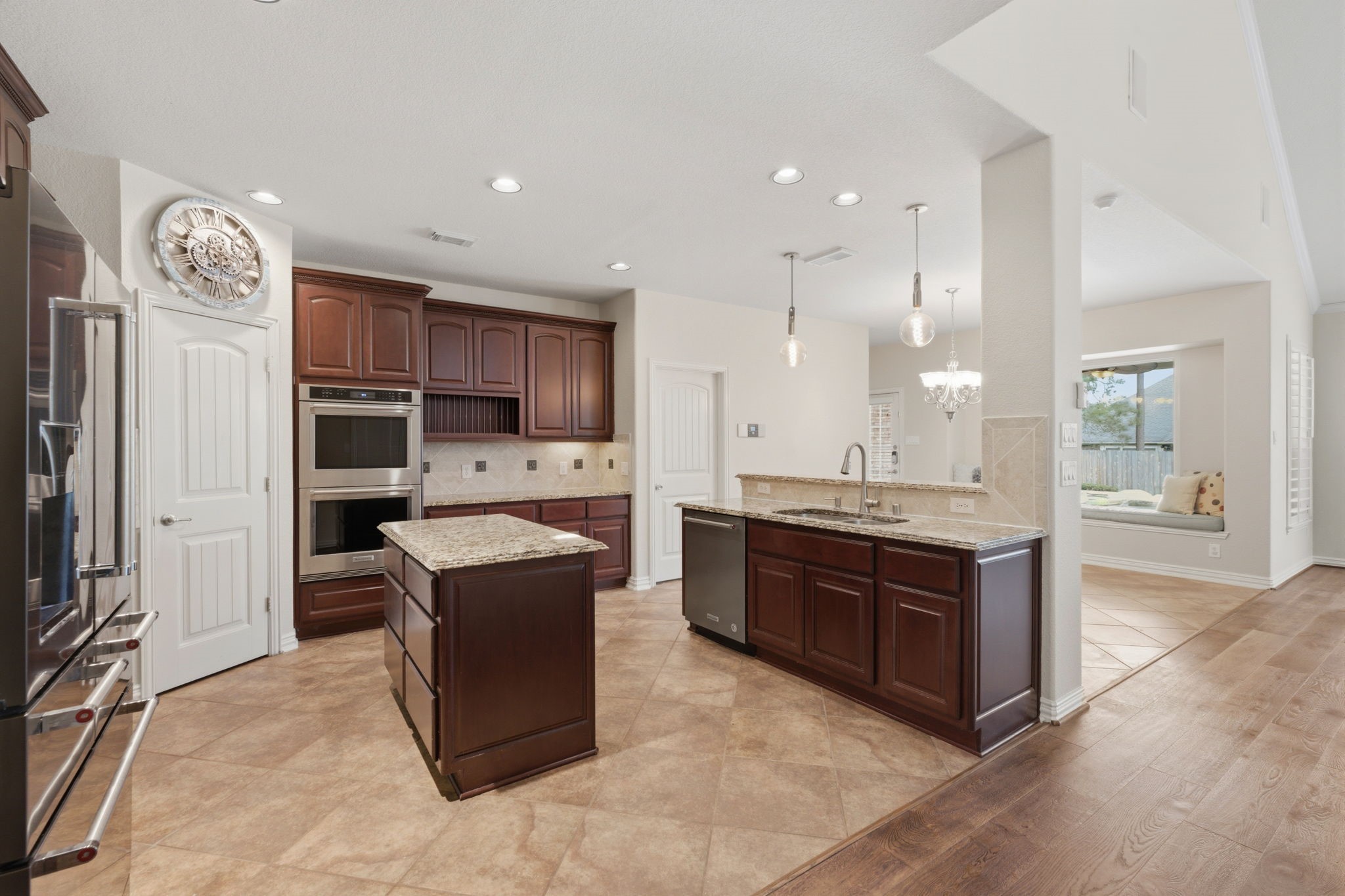 315 Arbor Ridge Lane Conroe, TX 77384 - Photo 16 of 48 a large kitchen with a large counter top stainless steel appliances and cabinets