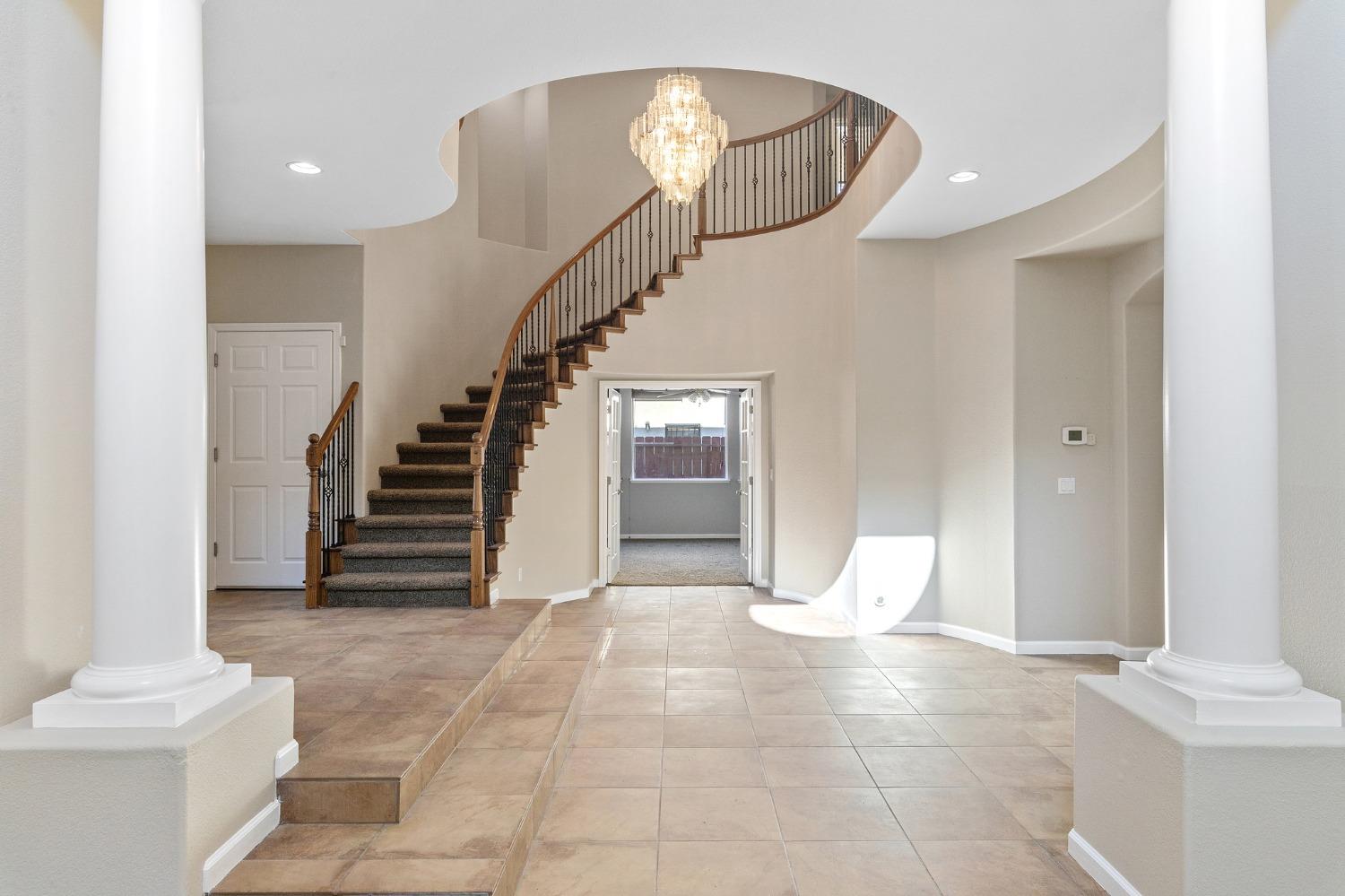 2090 Wisteria Place Manteca, CA 95337 - Photo 15 of 78 a view of an entryway with wooden floor and a chandelier