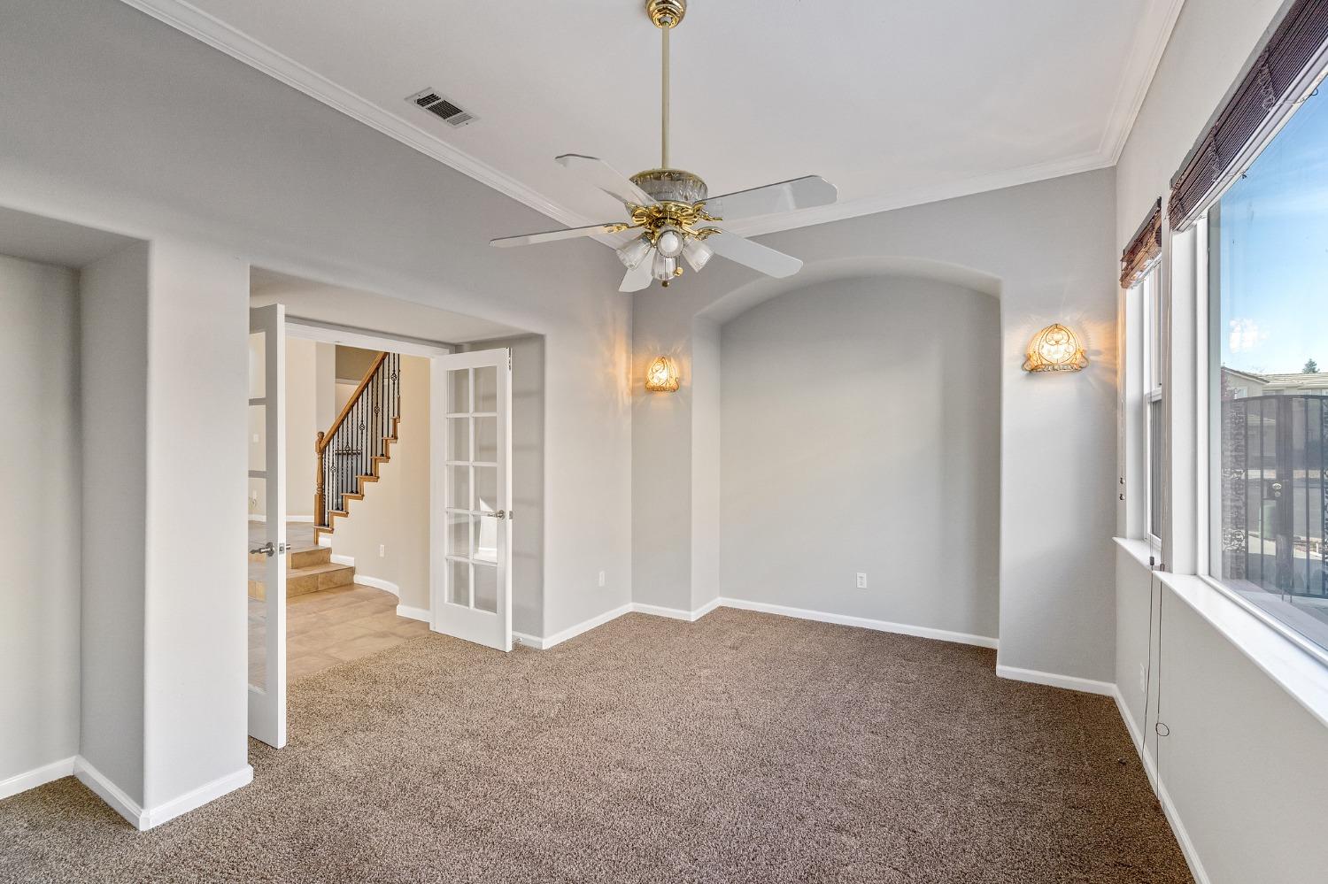 2090 Wisteria Place Manteca, CA 95337 - Photo 16 of 78 a view of a livingroom with a chandelier fan and windows
