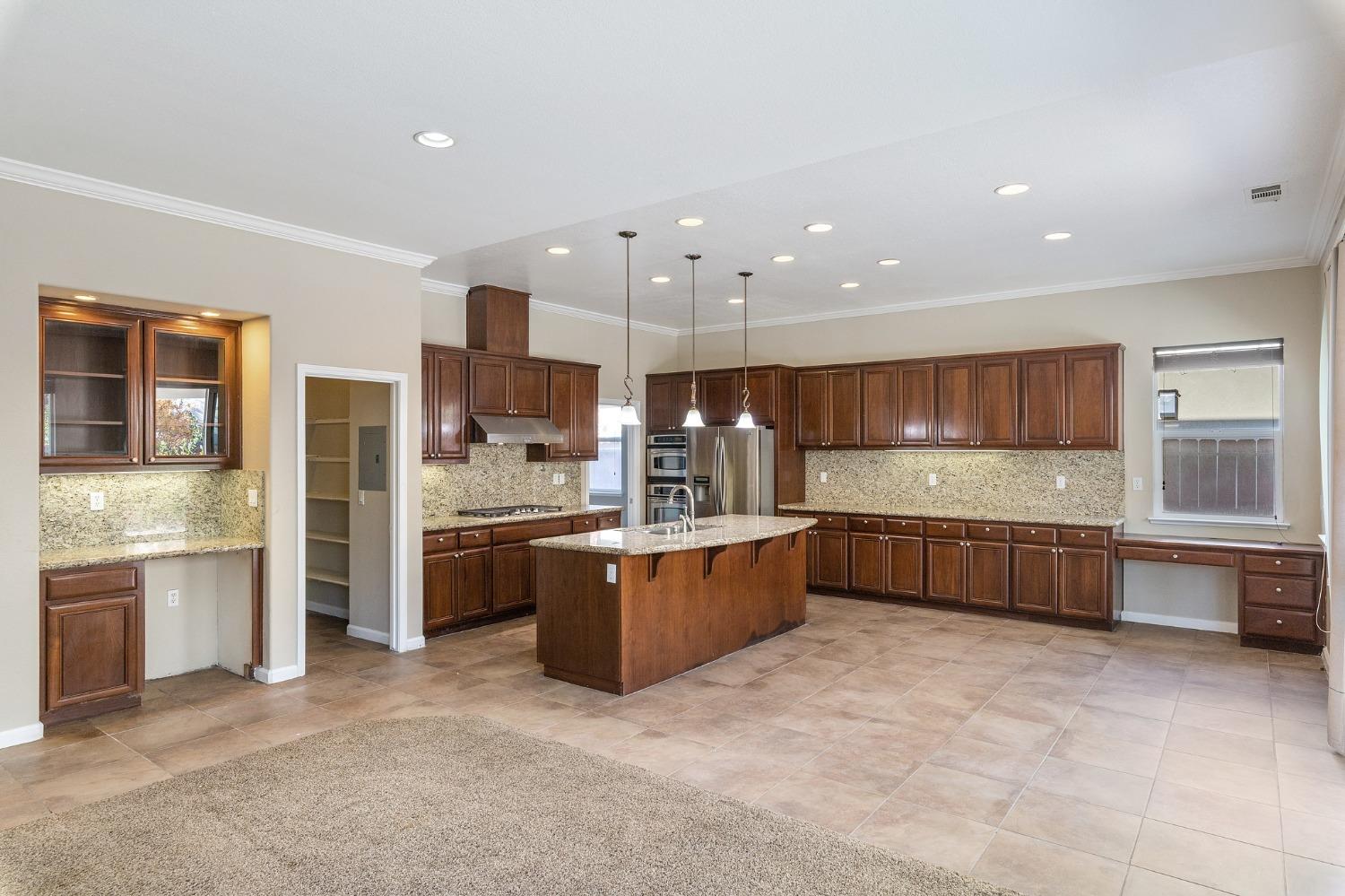 2090 Wisteria Place Manteca, CA 95337 - Photo 22 of 78 a large kitchen with stainless steel appliances lots of counter top space