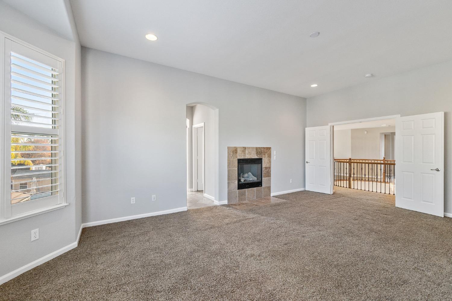 2090 Wisteria Place Manteca, CA 95337 - Photo 35 of 78 an empty room with windows and fireplace