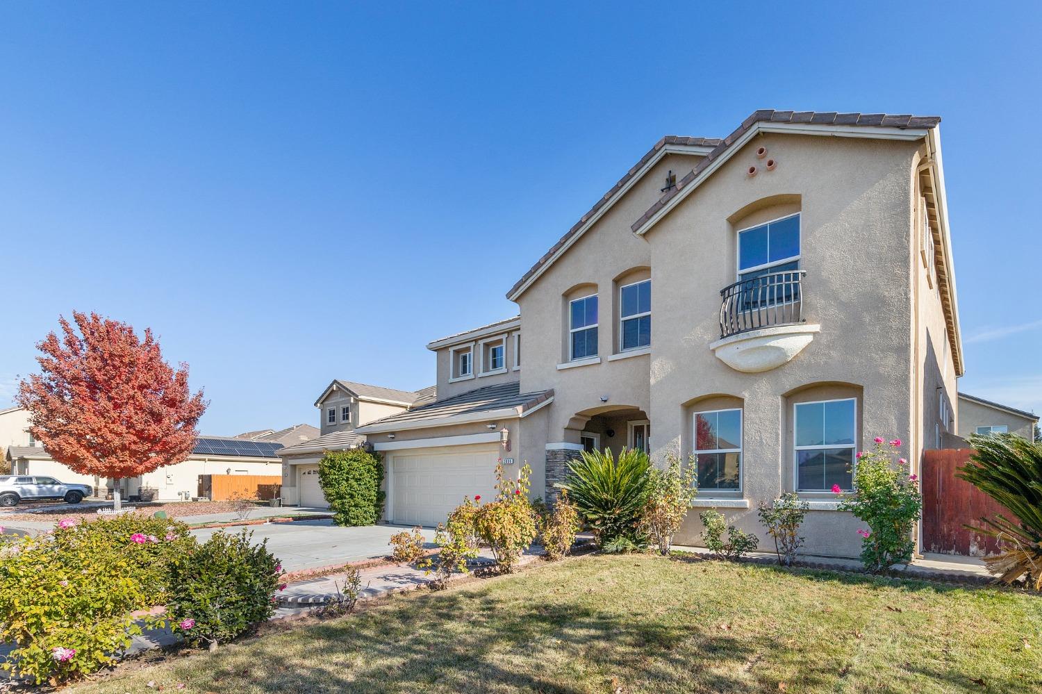 2090 Wisteria Place Manteca, CA 95337 - Photo 4 of 78 a front view of a house with a yard