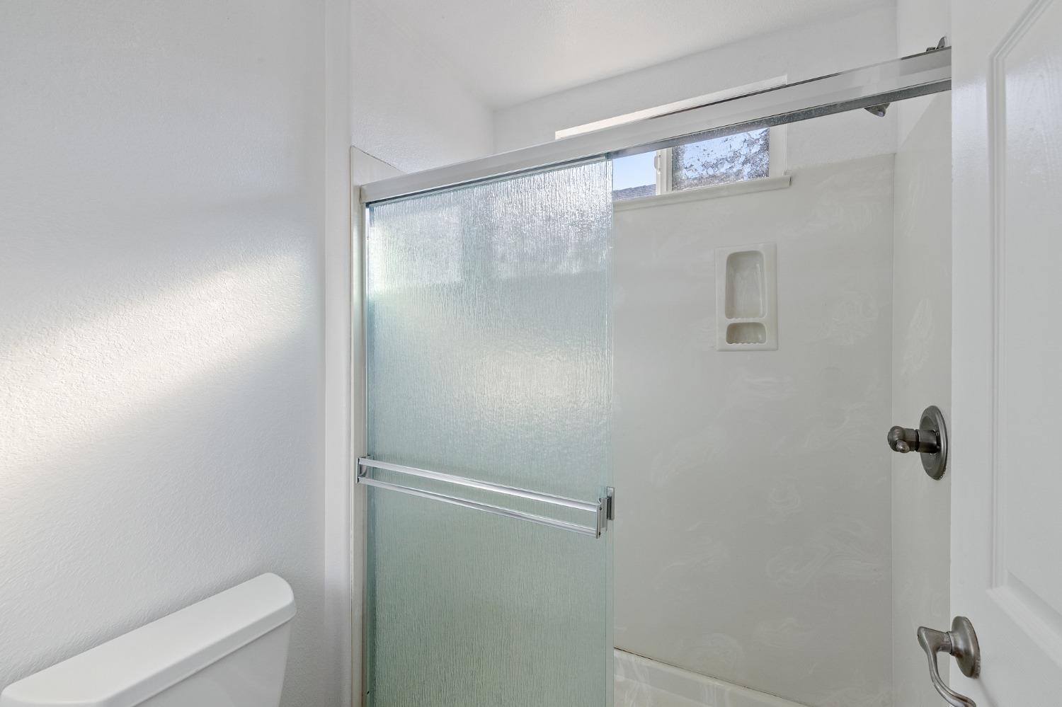 2090 Wisteria Place Manteca, CA 95337 - Photo 48 of 78 a bathroom with a glass shower door