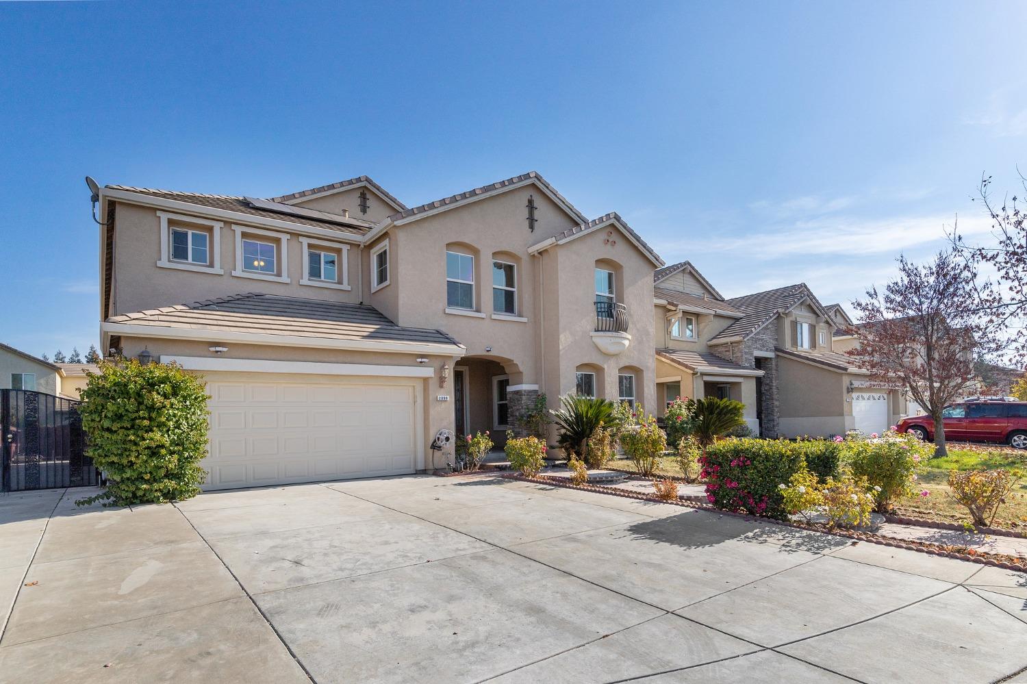 2090 Wisteria Place Manteca, CA 95337 - Photo 5 of 78 a front view of a house with a yard and garage