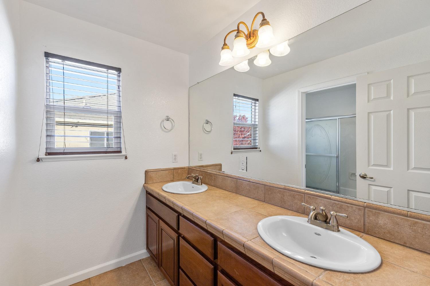 2090 Wisteria Place Manteca, CA 95337 - Photo 55 of 78 a bathroom with a sink a vanity and a mirror